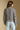 Back view of a woman wearing the Saltwater Luxe Aden Sweater on a neutral background
