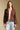 Front view of a woman wearing the Saltwater Luxe Aden Sweater and jeans on a neutral background with hands at sides