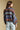 Back view of a woman wearing the Saltwater Luxe Aden Sweater on a neutral background with jeans