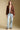 A full body front view of a woman wearing the Saltwater Luxe Aden Sweater on a neutral background