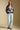 A full body front view of a woman wearing the Saltwater Luxe Aden Sweater on a neutral background