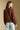 Back view of a woman wearing the Saltwater Luxe Aden Sweater and jeans on a neutral background