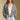 Front view of a woman wearing the Saltwater Luxe Aden Sweater on a neutral background with hands in pockets