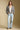 A full body front view of a woman wearing the Saltwater Luxe Aden Sweater on a neutral background