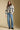 A full body front view of a woman wearing the Saltwater Luxe Alamere Sweater on a neutral background
