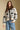Front view of a woman wearing the Saltwater Luxe Alamere Sweater on a neutral background with hand in pocket