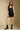 A full body front view of a woman wearing the Saltwater Luxe Andie Mini Skirt and matching Evrra Top on a neutral background