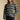 Front view of a woman wearing the Saltwater Luxe Arella Sweater on a neutral background with hand in pocket of black pants