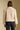 Back view of a woman wearing the Saltwater Luxe Ash Jacket on a neutral background