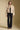 A full body front view of a woman wearing the Saltwater Luxe Ash Jacket on a neutral background
