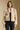 Front view of a woman wearing the Saltwater Luxe Ash Jacket on a neutral background over black jeans