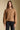 Front view of a woman wearing the Saltwater Luxe Aven Sweater on a neutral background with black pants
