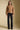 A full body front view of a woman wearing the Saltwater Luxe Aven Sweater on a neutral background