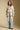 A full body front view of a woman wearing the Saltwater Luxe Birdy Sweater on a neutral background