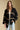 Front view of a woman wearing the Saltwater Luxe Birdy Sweater on a neutral background with hands at sides