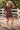 Front view of a woman wearing the Saltwater Luxe Ginna Mini Dress with hat and boots in a corral