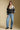 A full body front view of a woman wearing the Saltwater Luxe Cain Sweater on a neutral background