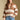 Front view of a woman wearing the Saltwater Luxe Cain Sweater with hand in pocket