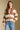 Front view of a woman wearing the Saltwater Luxe Cain Sweater with hand in pocket