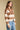 Side angle view of a woman wearing the Saltwater Luxe Cain Sweater with hand lowered