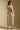 Back view of a woman wearing the Saltwater Luxe Calystah Midi Dress on a neutral background