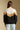 Back view of a woman wearing the Saltwater Luxe Camron Sweater on a neutral background in jeans