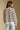 Back view of a woman wearing the Saltwater Luxe Camron Sweater on a neutral background in jeans