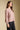 Side angle view of a woman wearing the Saltwater Luxe Camron Sweater on a neutral background with hands at sides
