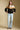 A full body front view of a woman wearing the Saltwater Luxe Camron Sweater on a neutral background