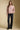 A full body front view of a woman wearing the Saltwater Luxe Camron Sweater on a neutral background