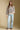 A full body front view of a woman wearing the Saltwater Luxe Camron Sweater on a neutral background