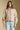 Front view of a woman wearing the Saltwater Luxe Deeda Jacket on a neutral background with blue jeans and arms at sides