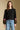 Front view of a woman wearing the Saltwater Luxe Darra Sweater on a neutral background with hands at sides