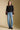 A full body front view of a woman wearing the Saltwater Luxe Darra Sweater on a neutral background