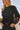 Front view of a woman wearing the Saltwater Luxe Darra Sweater with hands in pockets