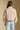 Back view of a woman wearing the Saltwater Luxe Deeda Jacket on a neutral background with hands at her sides