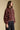 Side angle view of a woman wearing the Saltwater Luxe Deeda Jacket on a neutral background with black jeans