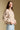 Side angle view of a woman wearing the Saltwater Luxe Deeda Jacket on a neutral background with blue jeans