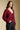 Side angle view of a woman wearing the Saltwater Luxe Dovere Sweater on a neutral background with black eans