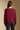 Back view of a woman wearing the Saltwater Luxe Dovere Sweater on a neutral background with arms at sides