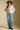 A full body front view of a woman wearing the Saltwater Luxe Dovere Sweater on a neutral background