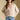 Front view of a woman wearing the Saltwater Luxe Dovere Sweater on a neutral background with blue jeans and hat
