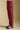 Side view of a woman wearing the Saltwater Luxe Elara Pant on a neutral background with shoes