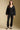 Full body front view of a woman wearing the Saltwater Luxe Ellyn Sweater set on a neutral background