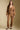 A full body front view of a woman wearing the Saltwater Luxe Ellyn Sweater on a neutral background