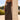Front view of a woman wearing the Saltwater Luxe  Enza Midi Dress leaning on a column