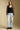 A full body front view of a woman wearing the Saltwater Luxe Evrra Top on a neutral background