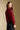 Back view of a woman wearing the Saltwater Luxe Finnian Sweater on a neutral background looking over one shoulder