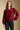 Front view of a woman wearing the Saltwater Luxe Finnian Sweater on a neutral background with hand on one hip