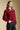 Side angle view of a woman wearing the Saltwater Luxe Finnian Sweater on a neutral background with hand in one pocket